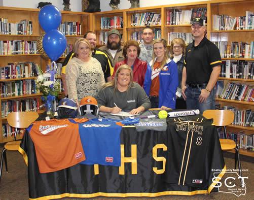 Kaylie Bush is pictured above with family and coaches on signing day in the Timpson ISD Library.