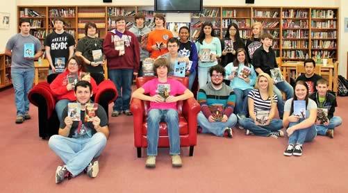 Members of the SHS Dragon Power Readers Book Club are shown with the new books donated by JML Management, Inc.
