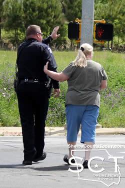 Center Police Officer John Welch is seen escorting a woman who knew one of the drivers, safely across Hurst Street. 