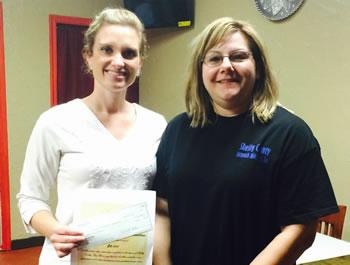 From left: Anna Lee presents donation to Sherry Harding, SC Outreach Ministries Executive Director