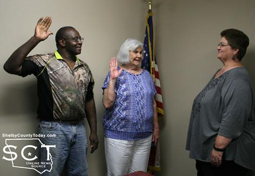 From left: Frankie Cooper and Pat Gray are sworn in by Donna Pugh.