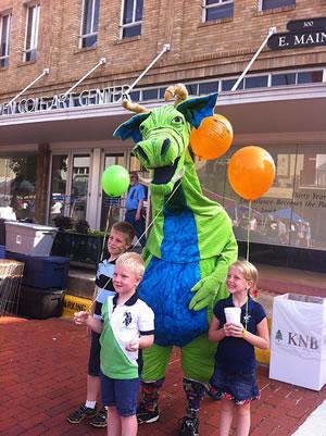 The SFA School of Theatre’s popular dragon character, Schlaftnicht, always draws a crowd at the annual Blueberry Festival in downtown Nacogdoches.