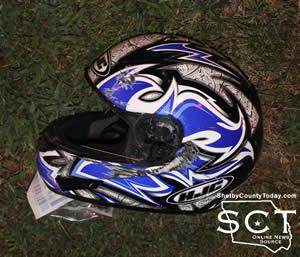 The helmet previously worn by the rider of the motorcycle appeared to have taken damage as a result of the crash not inflicted on the rider.