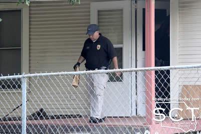 Center Police Detective David Haley is seen exiting 1160 Garrett Street in Center with an evidence bag.