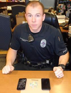 Center Police Officer Andrew Williams displays evidence collected during the traffic stop.