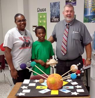 Pictured are (center) I’Morion McClelland, (right) Mike Furlow, S.W. Carter Elementary Principal and (left) Concynthia Garrett, I’Morion’s Mom.