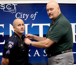 Chief Jim Albers pins Knowlton's sergeant badge to his uniform.