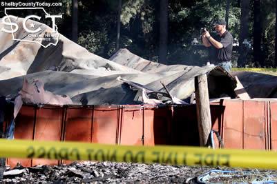 Robert Hairgrove, Constable Precinct 5, is seen photographing the burned residence at 795 CR 4699.