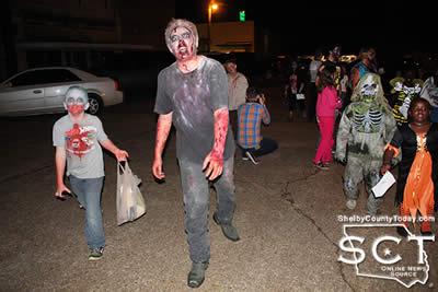 Zombies are seen above participating in the 1st Annual Zombie Walk in 2015.