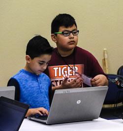 (From left) Jayden Beatriz and Jairo Hernandez programming their robot for competition.