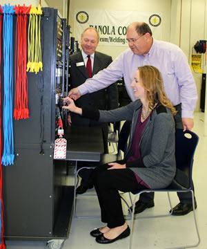 Natalie Oswalt, Dean of Professional and Technical Programs, along with Dr. Greg Powell, Panola College President, and Dr. Joe Shannon, Vice President of Instruction, check out a training unit in the technical laboratory on the Carthage campus. Additional training systems are available at the Shelby Regional Training Center in Center.