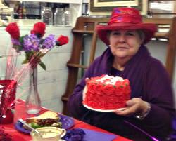 Judy Carrington and the birthday cake provided by The Little Fox Market Place.