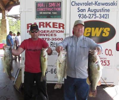 Photo of Sanderson and Addison with their winning stringer of 28.06lbs and big bass of the event at 10.56lbs.