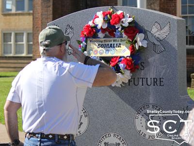 Sean Martin solutes the memorial wreath hung honoring those who served in Somalia.