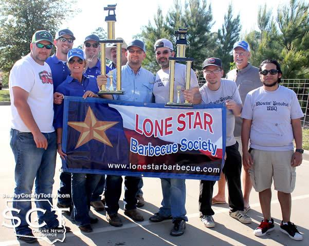 Shelby Savings Bank cook team (left) took the Grand Champion trophy at the 2017 Shelby County Grill Fest and Blowin' Smoke BBQ cook team (right) were awarded the Reserve Grand Champion trophy Saturday, April 8, 2017.