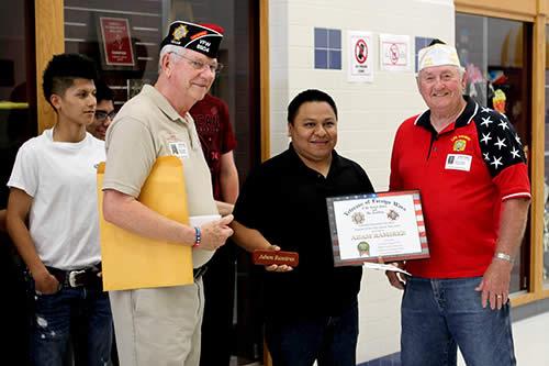 Post Commander Gene Hutto (red shirt) and Post Quartermaster Larry Hume present Adam with certificate, pen, and check.  
