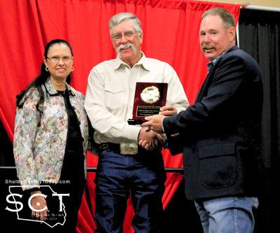 From left: Betty and Lane Chambers receive Farm Family of the Year award presented by Lane Dunn, AgriLife Extension Agent.