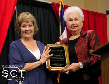 From left: Colleen Doggett is presented the Distinguished Service Award presented by Ann Forbes, the wife of the late Jim Forbes who received the award in 2016.