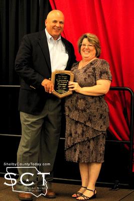 From left: Jim Sawyer receives a plaque recognizing his year as Chamber President from current President Meg Camp.