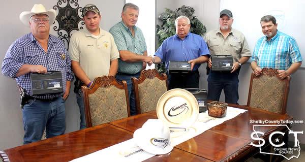 The Shelby County Constables received the donation of body cams from Gibsons on Saturday May 13, 2017. Pictured are (from left): Roy Cheatwood, Constable Precinct 3; Jake Metcalf, Constable Precinct 4; Zach Warr, Constable Precinct 1; Leonard Dupuis, Gibsons Regional Manager; Jamie Hagler, Constable Precinct 2; and Bobby Head, EPIC Plant Manager. Not pictured: Robert Hairgrove, Precinct 5 Constable.