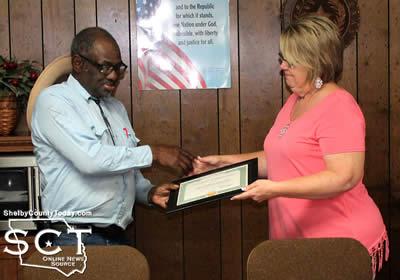 George Grace (left) is seen receiving a certificate of appreciation from Timpson Mayor Debra Pate Smith.