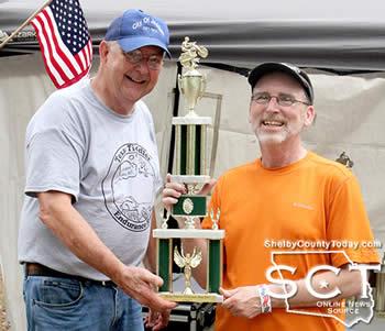 Lee Coltharp (right) was presented with the trophy for the 50CC class by Dennis Leggett (left).
