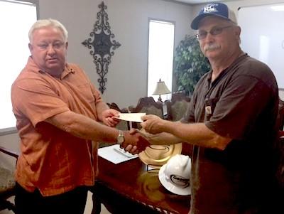 Pictured are (from left): Leonard Dupuis, Gibsons Regional Manager, presenting Glenn Johnson, past Shelbyville Lion’s Club President, with the check for $1,000.