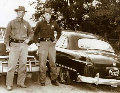 Texas game wardens have been looking out our natural resources since the late 1800's. Here, wardens Leo Kohleffel and Emmitt Wolfsdorff in 1952 with a vehicle that was seized after a road hunting incident in or near Colorado County. (TPWD Photo)