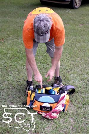 Craig Lewis displays a carrying bag with a variety of different discs with different purposes within the game.