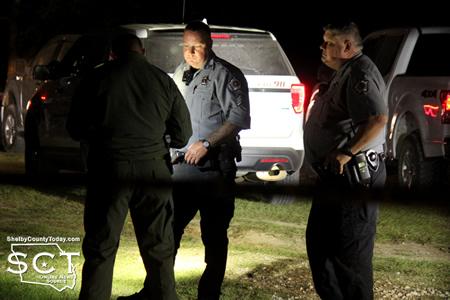Texas Ranger James Hicks (left) is seen speaking with Shelby County Sheriff's Deputies Jeff Gogolewski (middle) and Cody Muse (right).