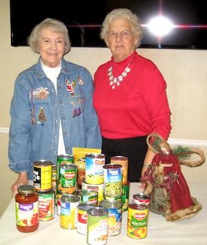 Golden Harvest Ministries Club 1st Vice President Linda Anderson and President Helen Collard are shown with can goods collected by members.