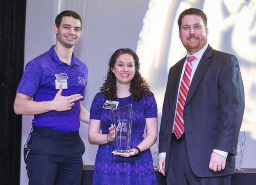 Collin Rutherford, left, graduate assistant of leadership and service at Stephen F. Austin State University, and Molly Moody, assistant director of student engagement at SFA, accept the Gulf Coast Regional Blood Center award for “College of the Year” from Kevin Shipley, director of donor recruitment, at the Celebration of Life luncheon held recently in Houston. According to blood center officials, since 2003, more than 17,000 units of blood have been collected as a result of SFA-hosted drives, saving 50,610 lives. In the days following Hurricane Harvey, a drive on the SFA campus resulted in the donation of more than 150 units of blood.