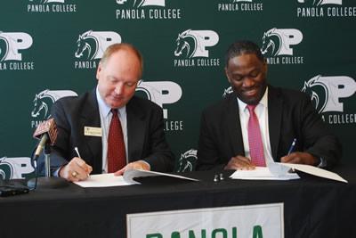 Dr. Greg Powell, president of Panola College, and Dr. Michael Tidwell, president of UT Tyler, sign the articulation agreement.
