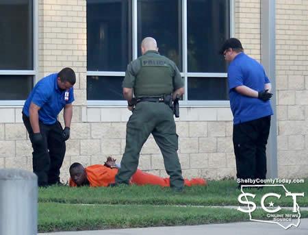 CPD Sgt. Chris Knowlton is seen with ACE EMS personnel and an inmate on the ground who had been tazed.