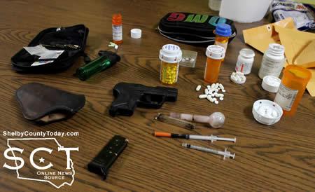 Pictured above are narcotics and a handgun recovered at the McCoy's residence.