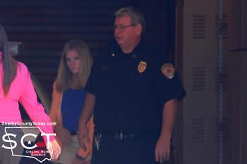 Jenny Rhodes-Cassell is seen being escorted into the Shelby County Jail by Center ISD Police Chief Pete Low and Center Police Detective Nicole Faulkner.