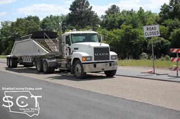 Another truck-tractor is seen stopped at the road closed sign by the intersection of FM 699 at the crash scene.