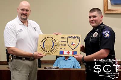 Center Police Chief (left) presents Center Police officer Jake Gross (right) with the Life Saving Award.