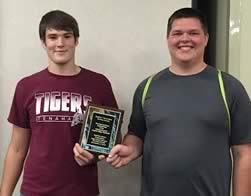 Blayne Cummings (left) and Jacob Samford (right) proudly display their third place plaque from the High School Region VII Robotics Competition.