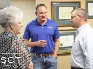 Warren visits with Tim Hopkins, new Branch Manager, and Will Lucas with Shelby Savings Bank who congratulates her on retirement.