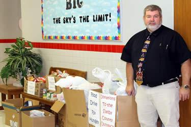 S.W. Carter Elementary Principal Mike Furlow stands beside the food donated by the elementary school.
