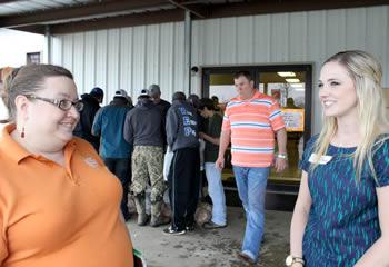 Lauren Hovey (right) visits with Michelle Rodriguez, East Texas Food Bank representative.