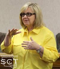 Anne Blackwell, Shelby County Treasurer, is seen describing the need for a dividing wall in her office.