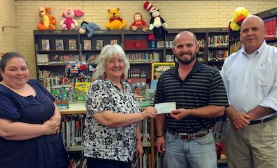 Fannie Brown Booth Memorial Library Director, Sandra Davis accepts a donation from Wil Blackshear, President Center Noon Lions Club for the 2016 Summer Reading Program.  From left to right, Cassey Fowler – Assistant Librarian, Sandra Davis, Wil Blackshear  and Jim Sawyer – Treasurer Center Noon Lions Club.