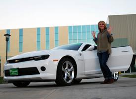 Rhonda Williams shows her excitement as a new owner of a 2015 Chevy Camaro.