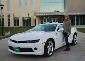 Rhonda Williams stands beside her new 2015 Chevy Camaro she won from the Panola College Foundation’s Cruisin’ for College Car Raffle.