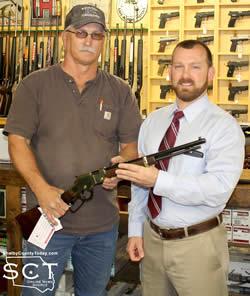 Casey Williams (right) is seen being presented with his rifle by Glenn Johnson, Shelbyville Lions Club President (left).